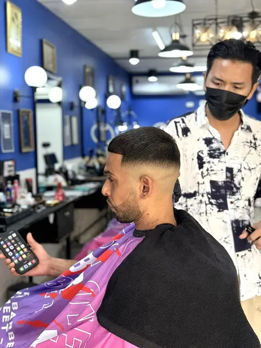Client enjoying a fresh cut at The Best Man